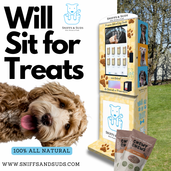 A vending machine selling dog treats in a scenic park. The text reads "Will sit for treats. www.sniffsandsuds.com"